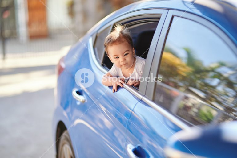 storyblocks-excited-baby-girl-looking-out-from-car-window-on-sunny-day_B2kS1n3IN_SB_PM